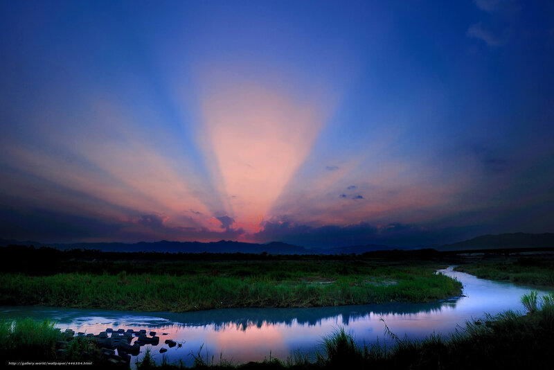 Sunset rays over river landscape