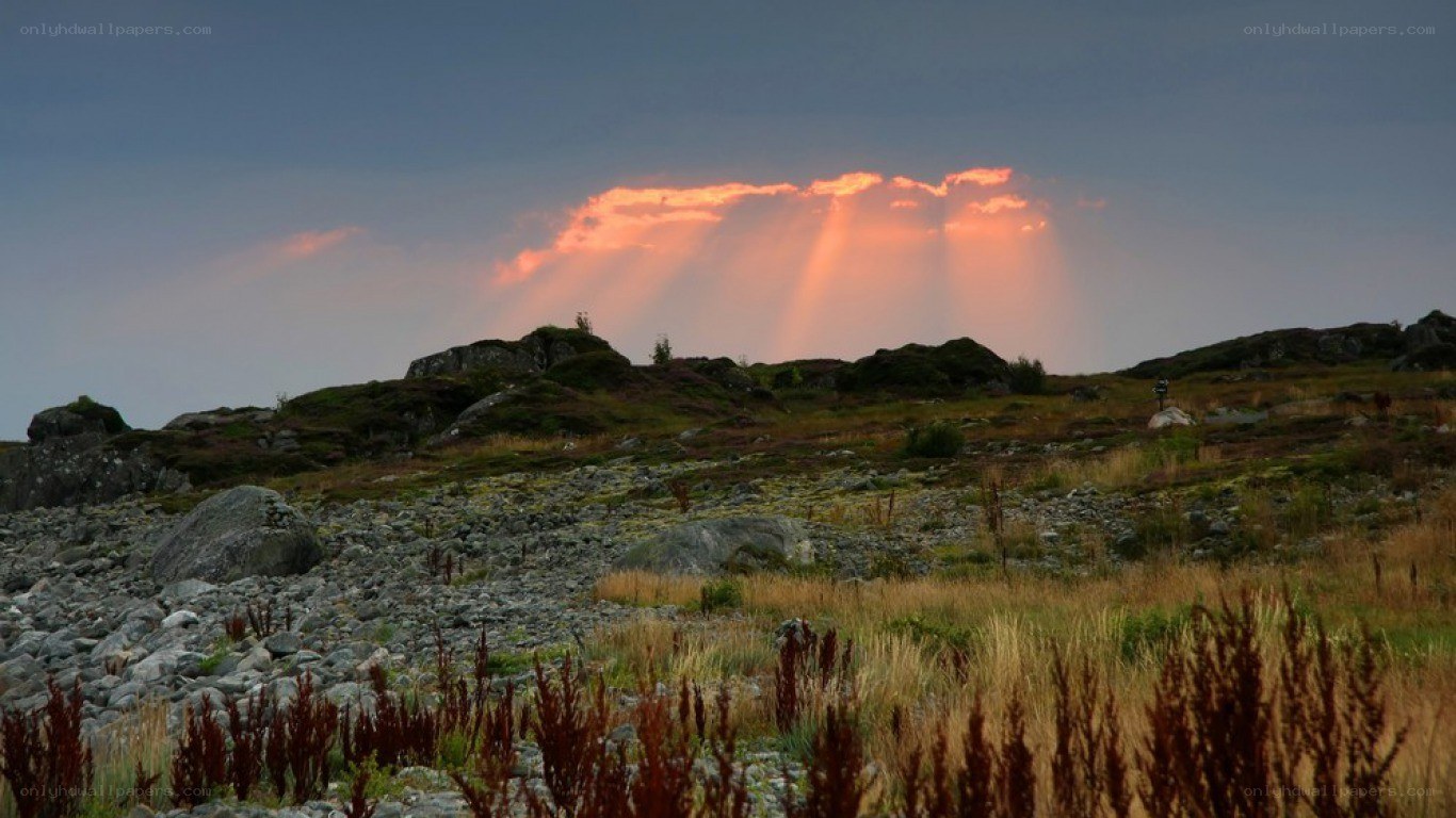 Sunset rays over rocky landscape