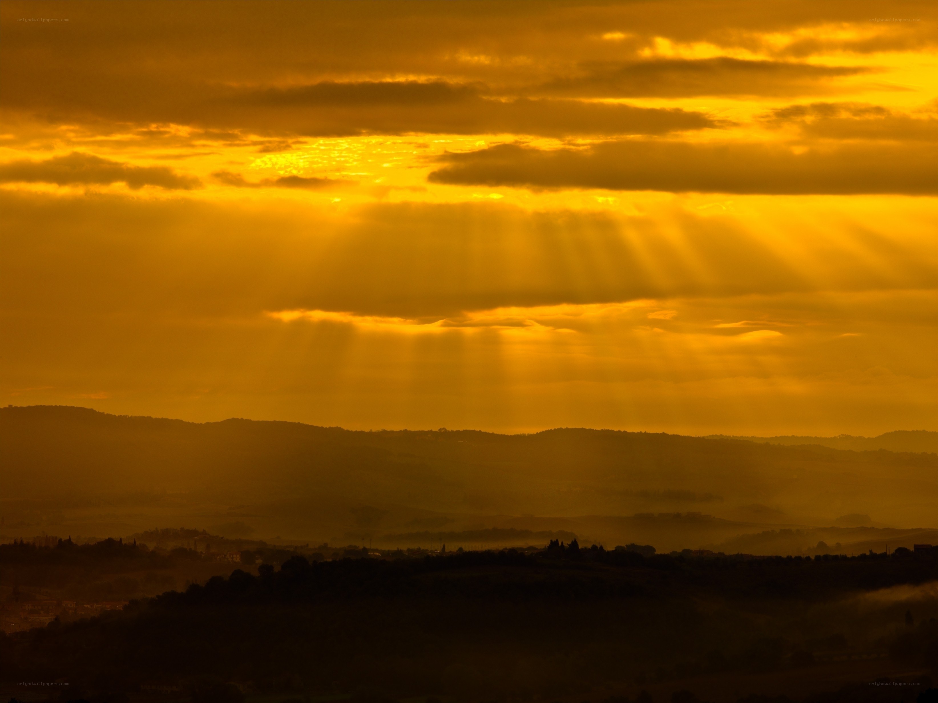 Sunset rays over rolling hills