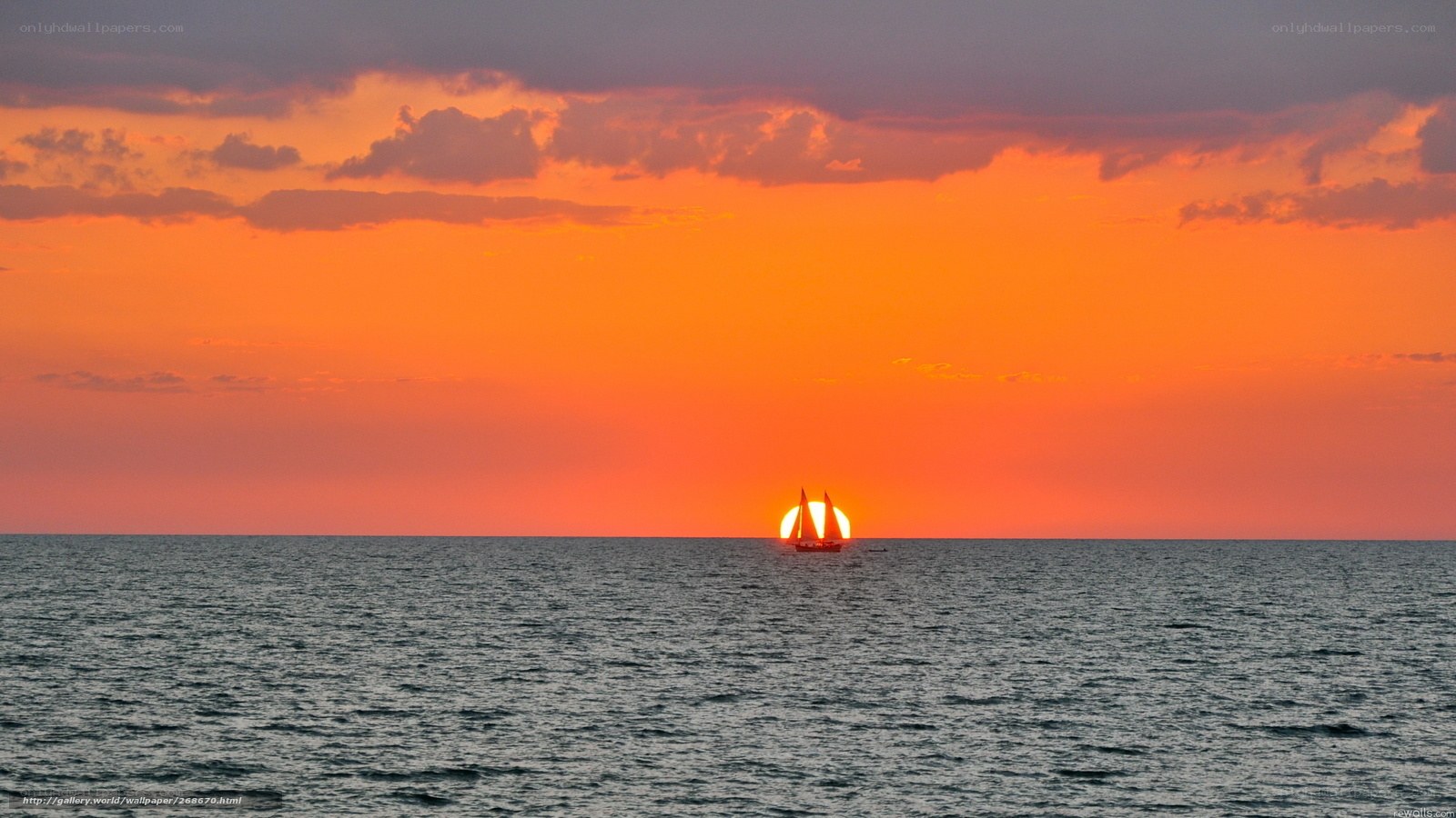 Sunset sailboat at sea