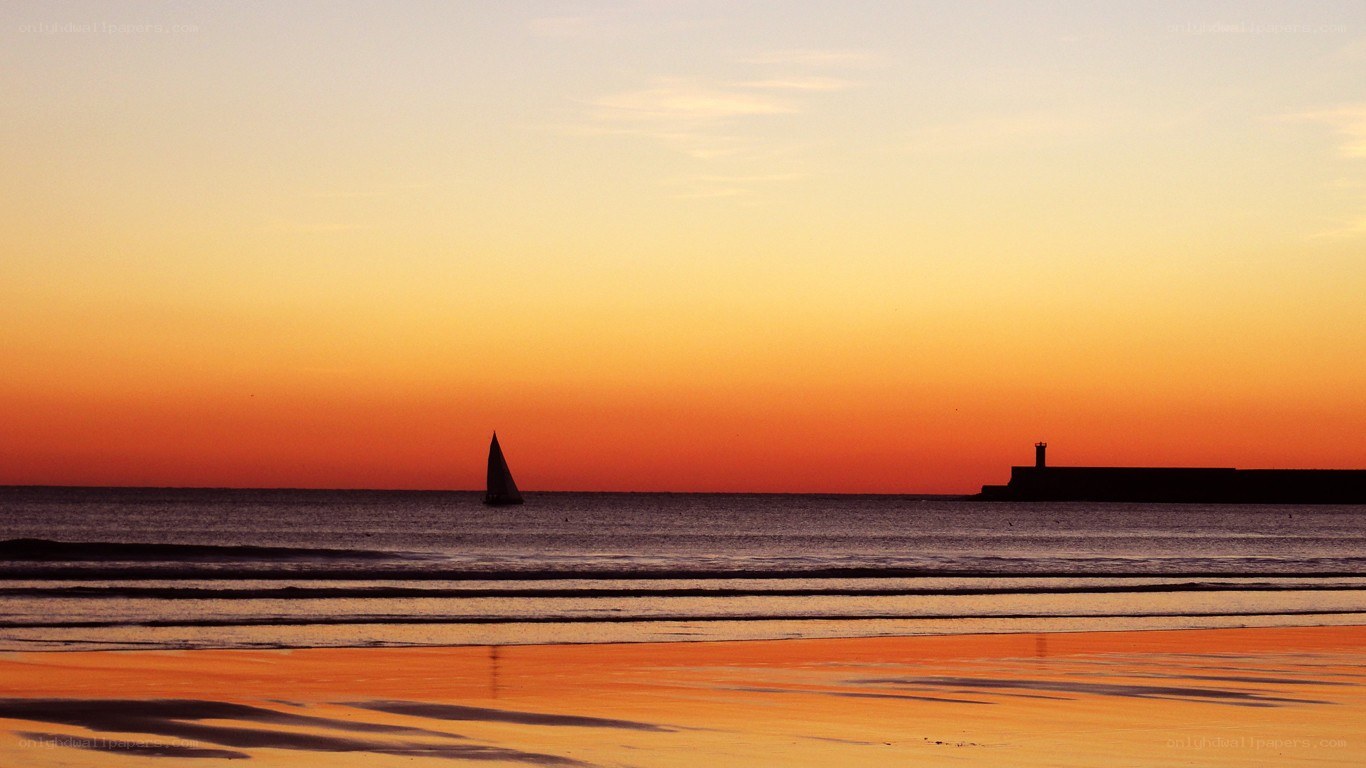 sunset sailboat at the beach