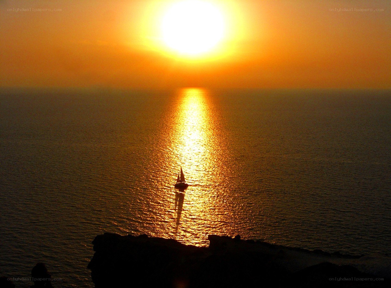 Sunset sailboat on calm sea