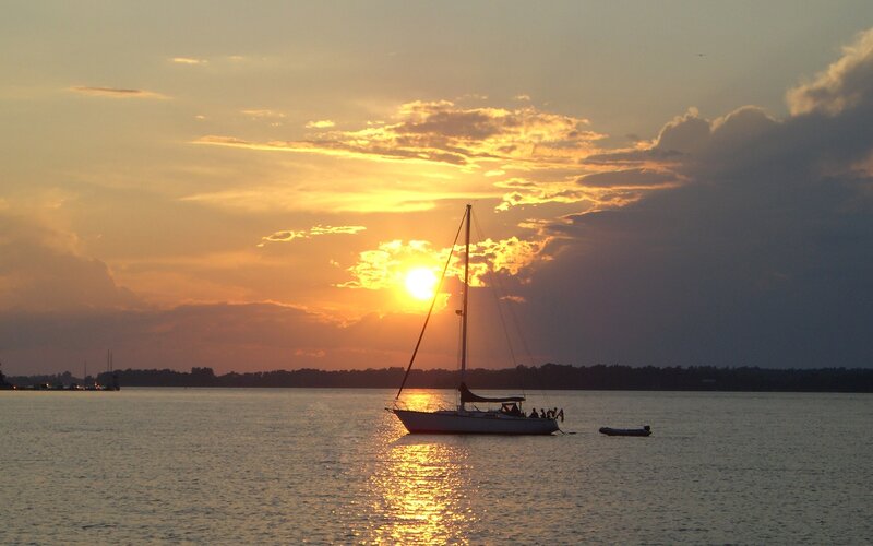 Sunset sailboat on calm water