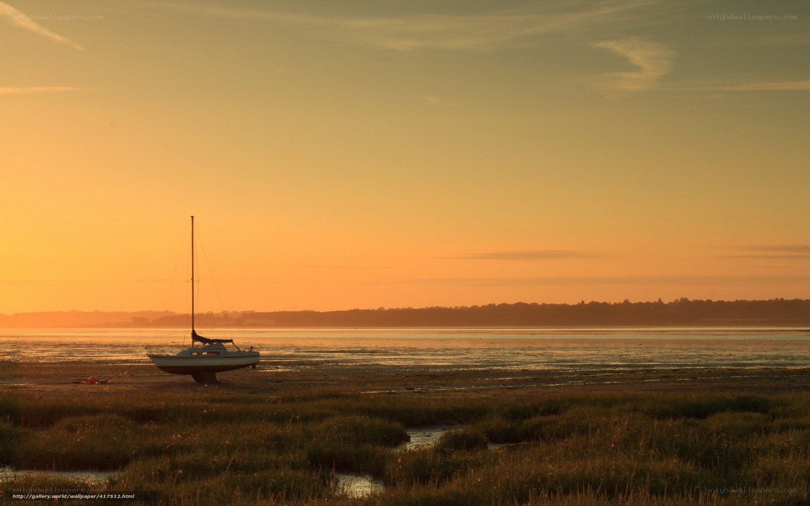sunset sailboat on the shore