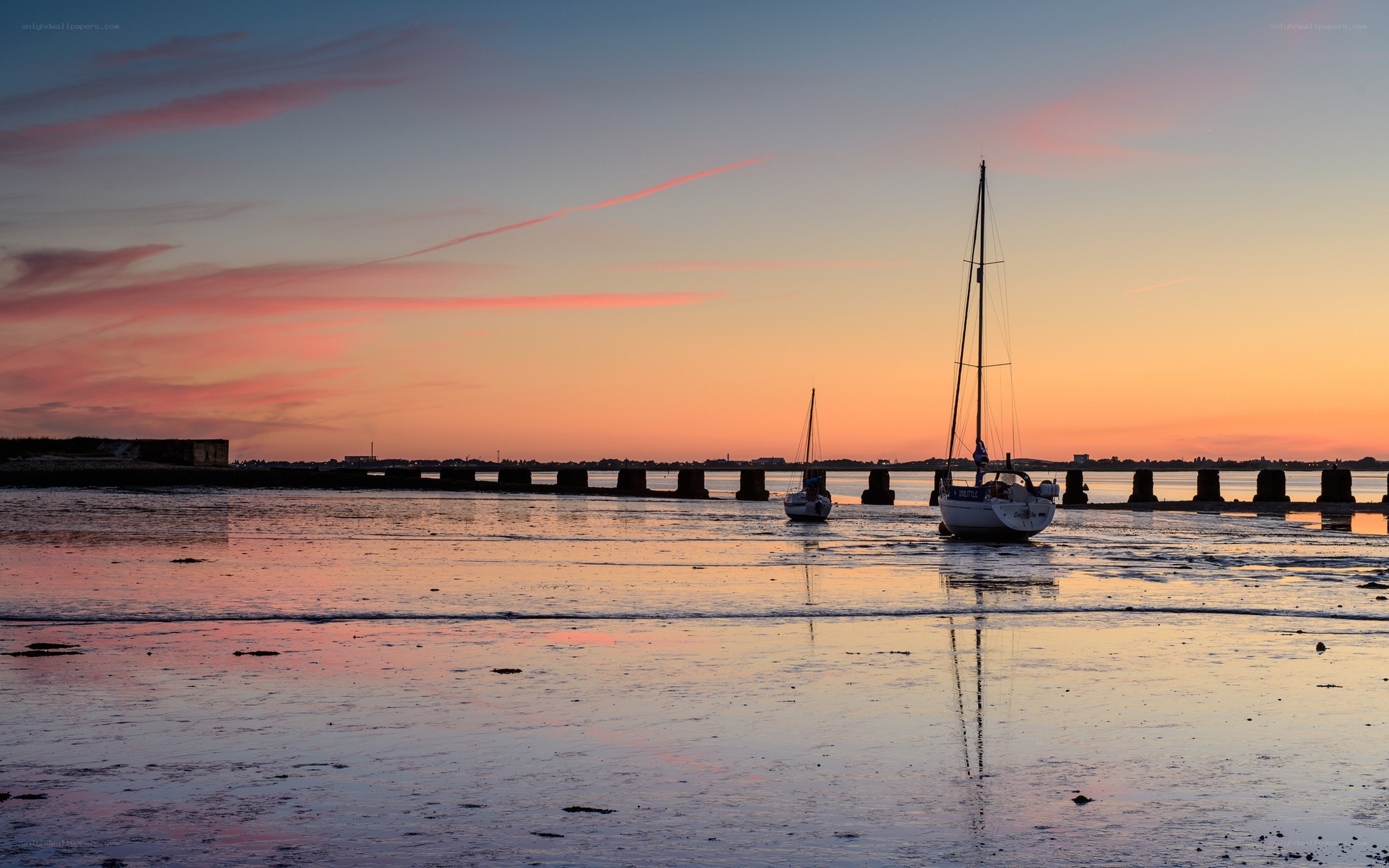 Sunset sailboats at low tide