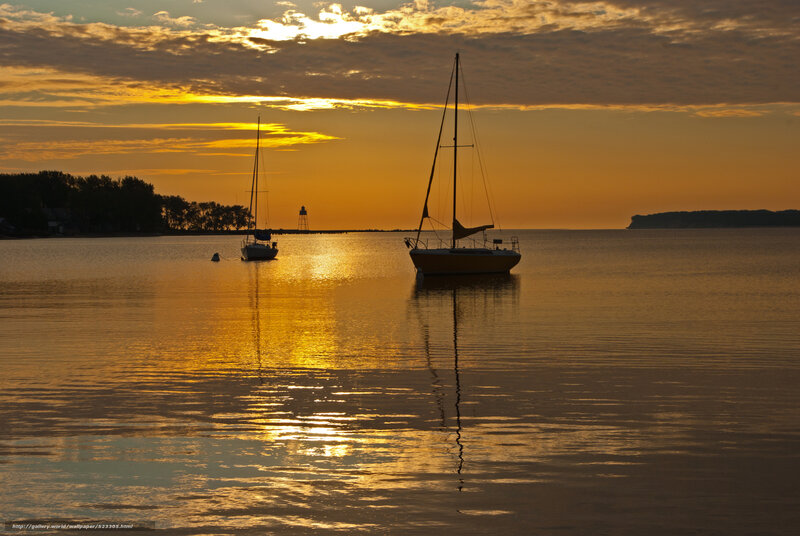 Sunset sailboats on calm water
