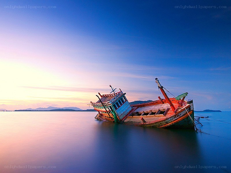 Sunset shipwreck on calm water