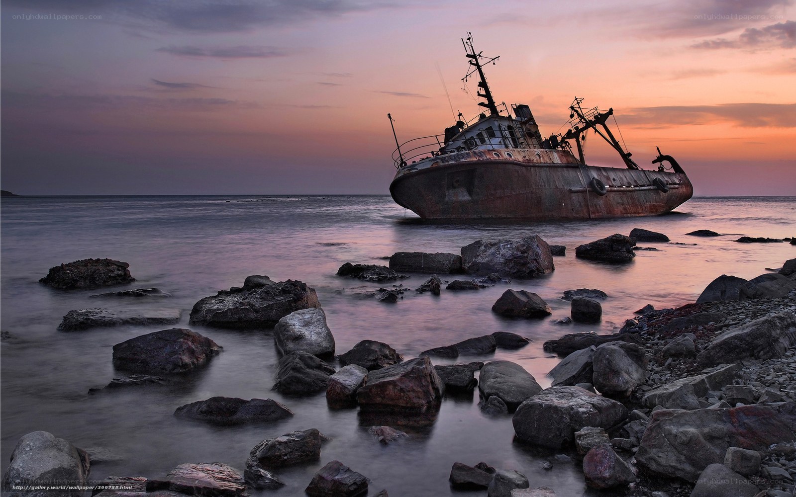 Sunset shipwreck on rocky shore