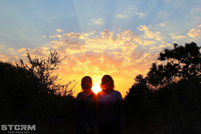 Sunset silhouette of two people