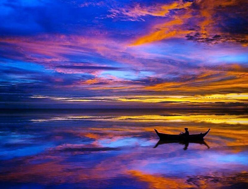 Sunset silhouette on calm water