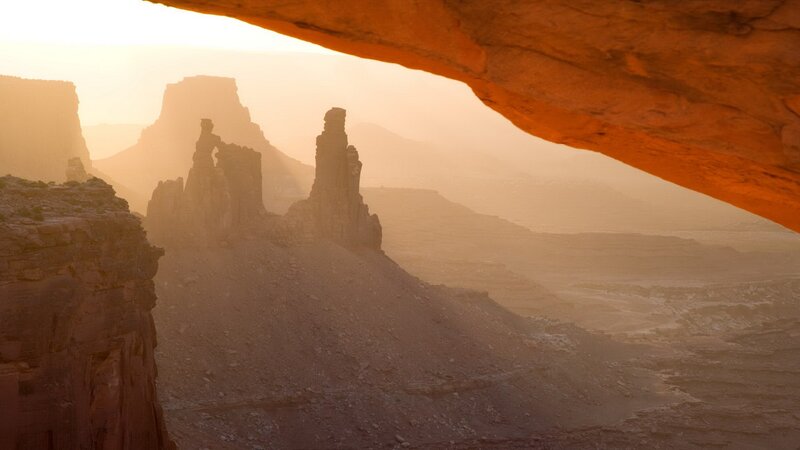 Sunset through a natural arch