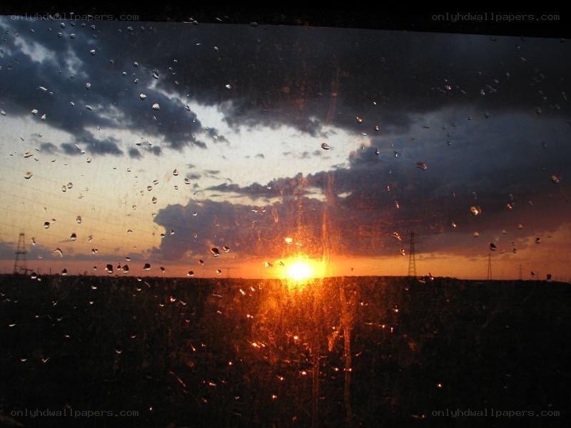 Sunset through a rain-streaked window
