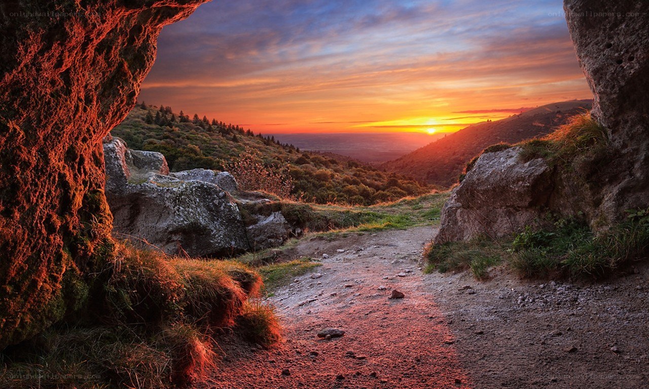 Sunset through a rocky arch