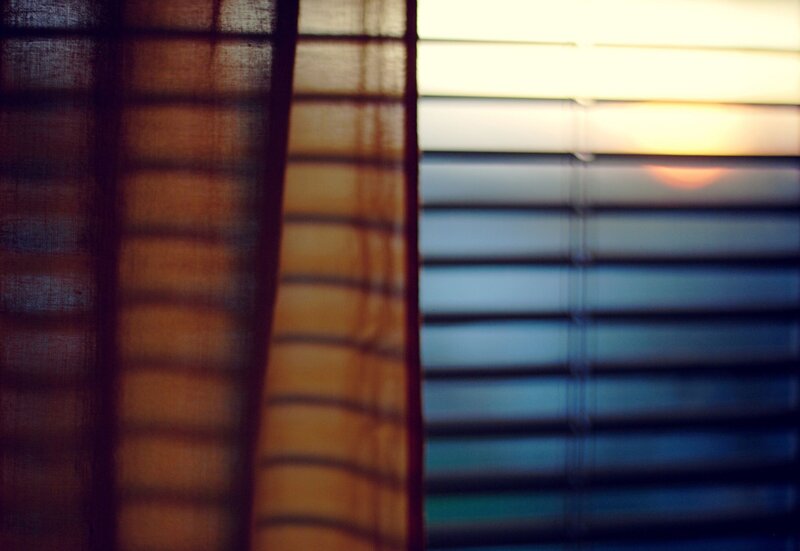 Sunset through blinds and curtain