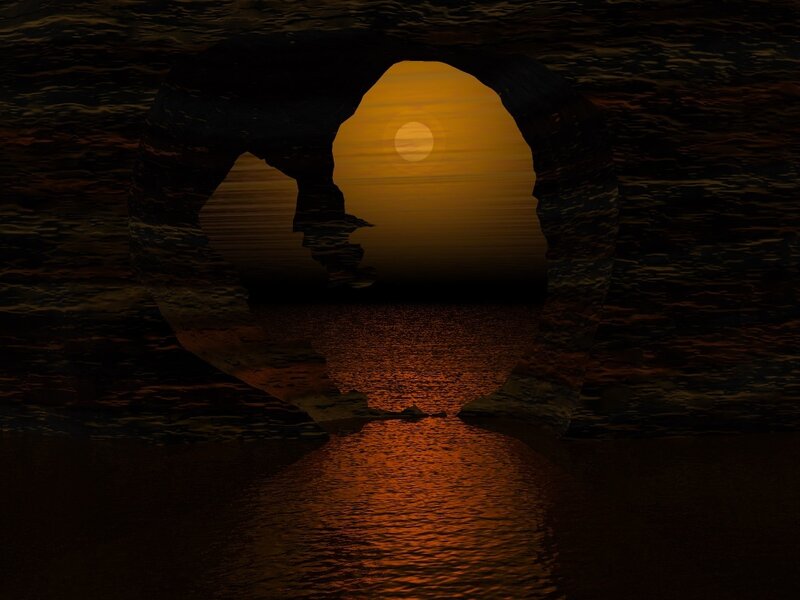 Sunset through cave arch