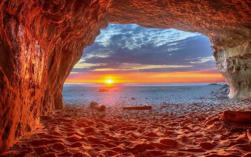 Sunset Through Cave Opening — Orange, Dramatic, Photograph