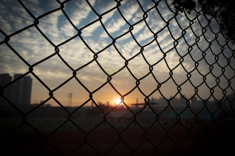 Sunset Through Chain-link Fence — Orange, Dramatic, Photograph