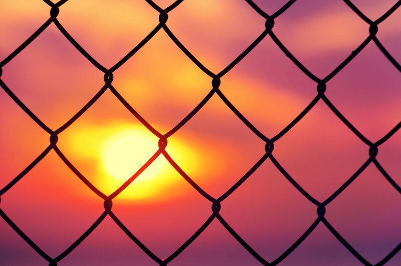 Sunset Through Chain-link Fence — Orange, Dramatic