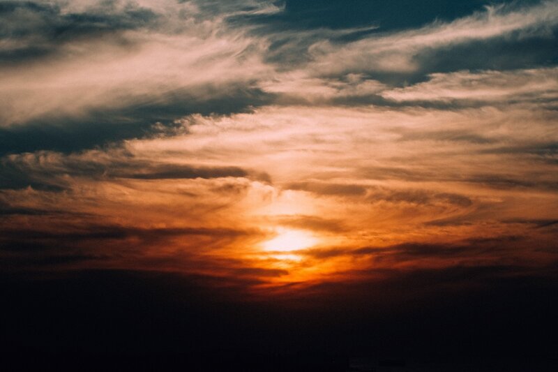 Sunset Through Clouds — Orange, Dramatic, Photograph