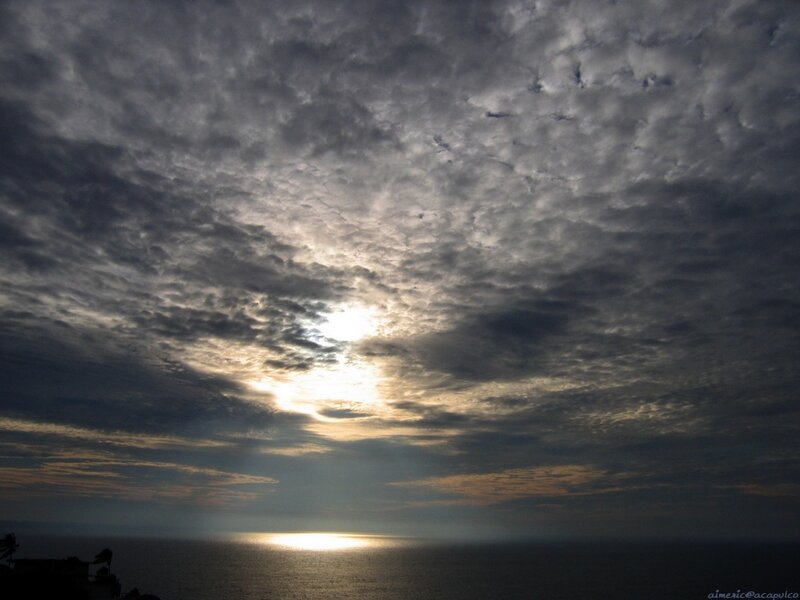 Sunset through cloudy sky