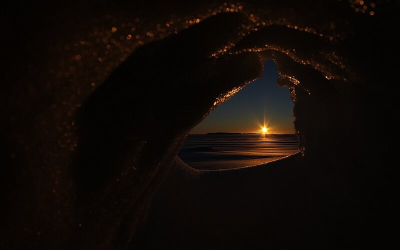 Sunset through ice tunnel