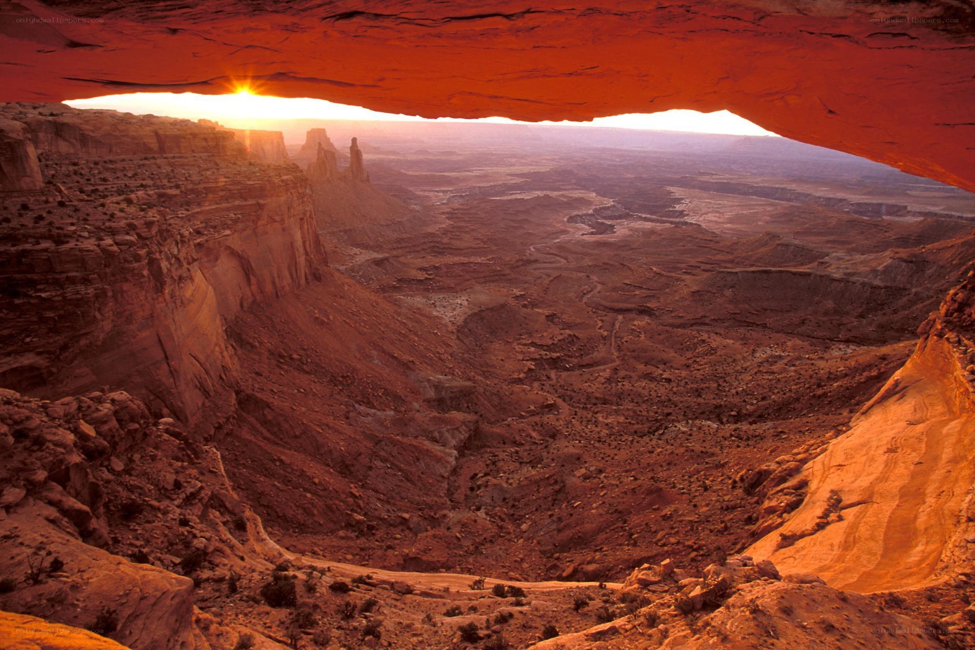 Sunset through natural rock arch