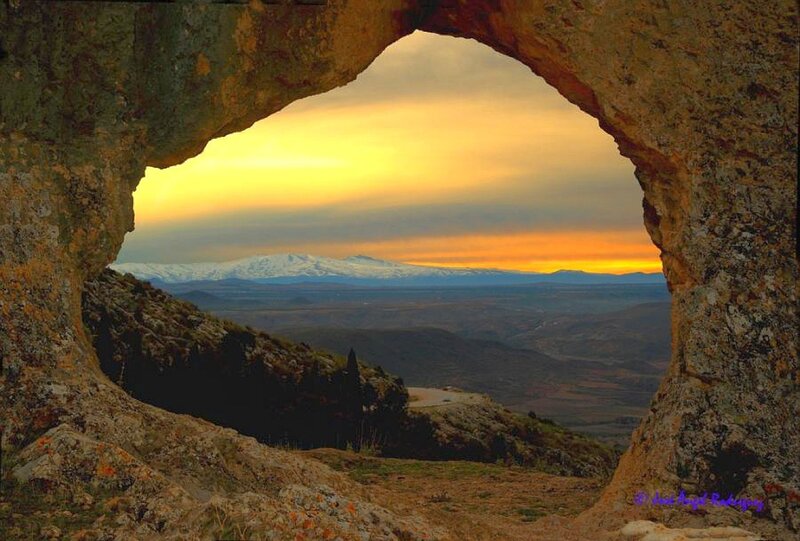 Sunset through natural rock arch