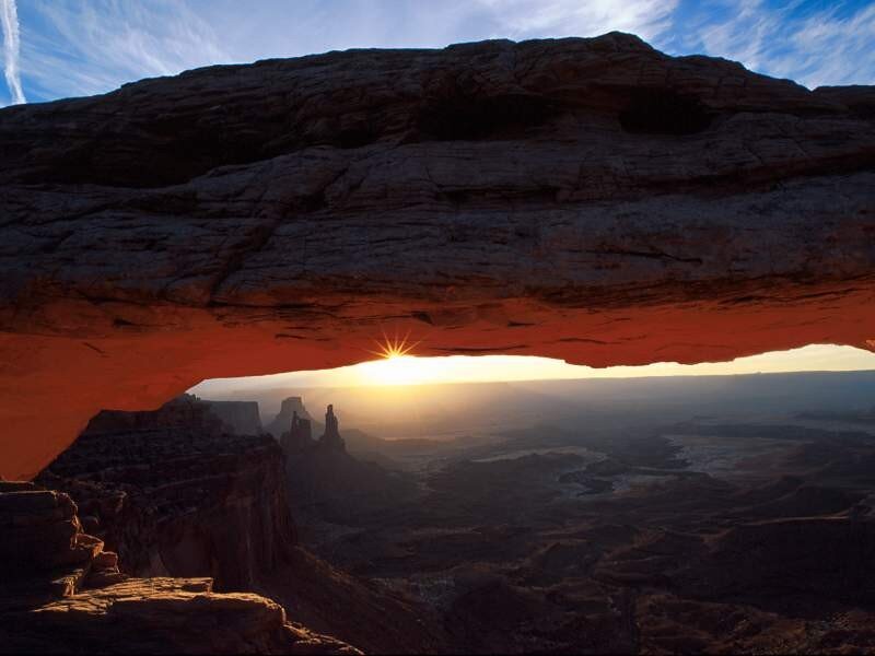 Sunset through natural rock arch