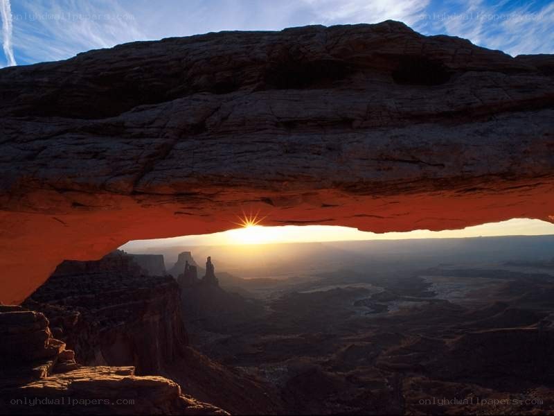 Sunset through natural rock arch