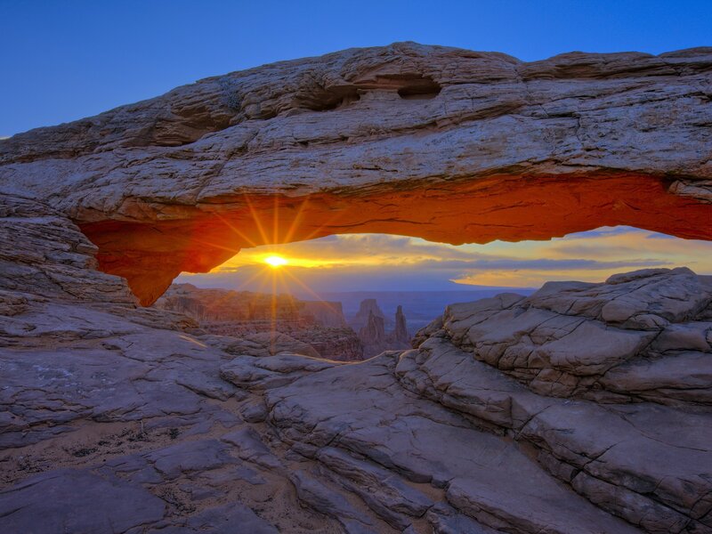 Sunset through natural rock arch