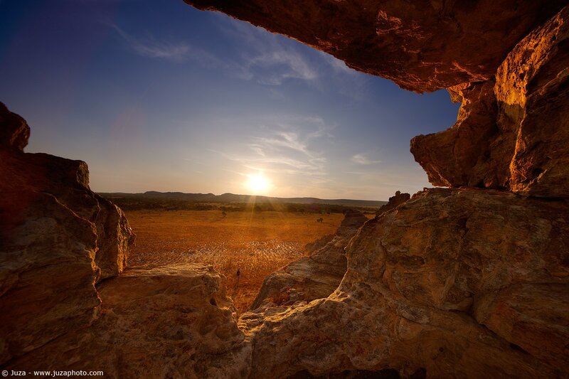 Sunset through rock arch