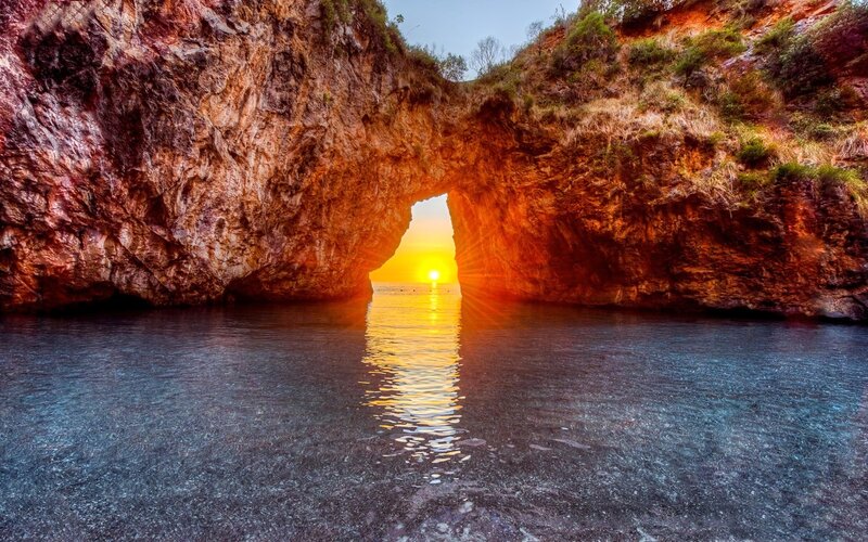 Sunset Through Rock Arch — Orange