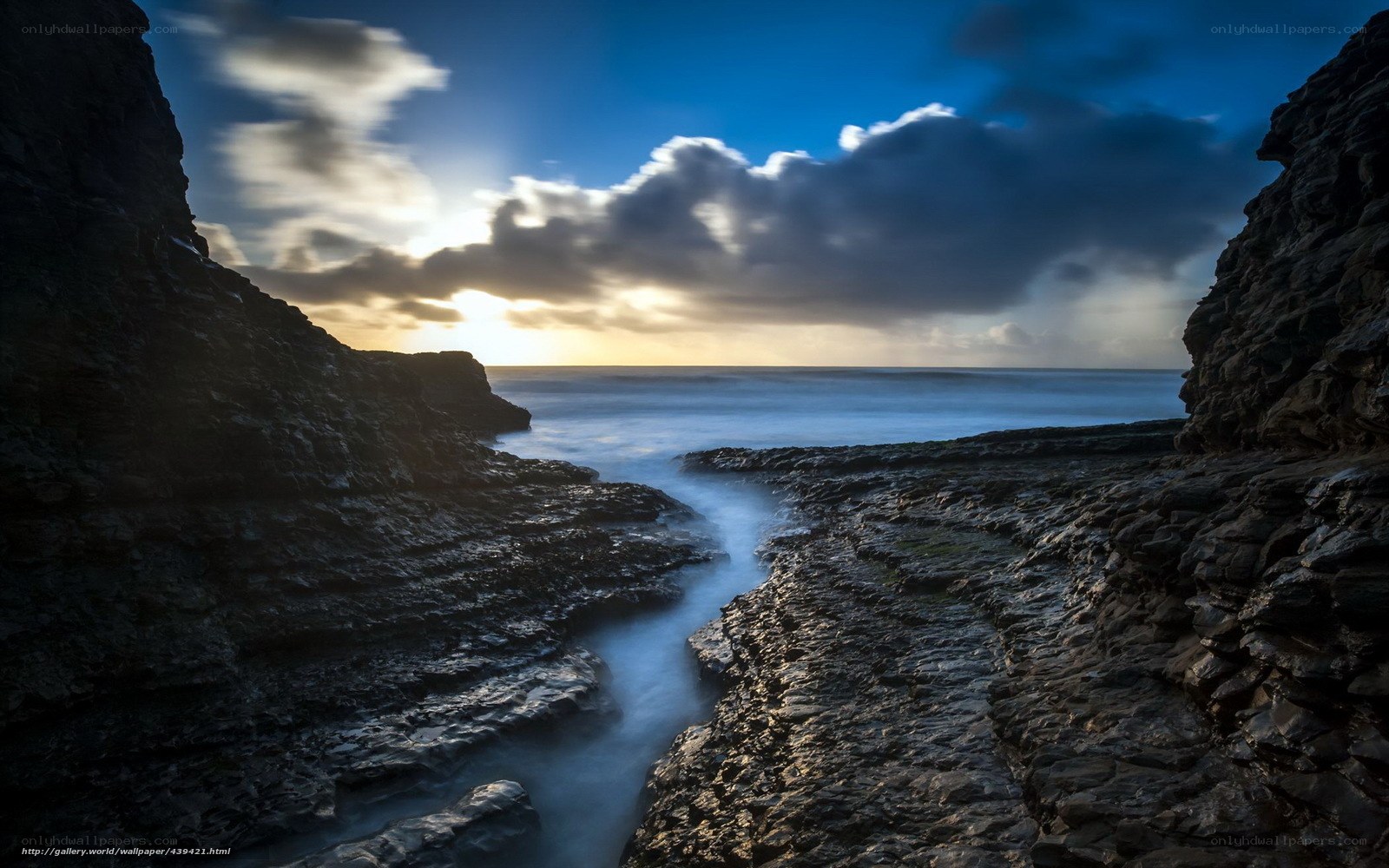 Sunset through rocky coastal passage