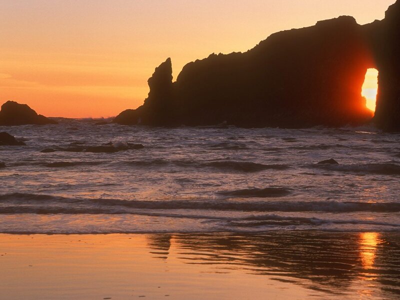 Sunset through sea arch