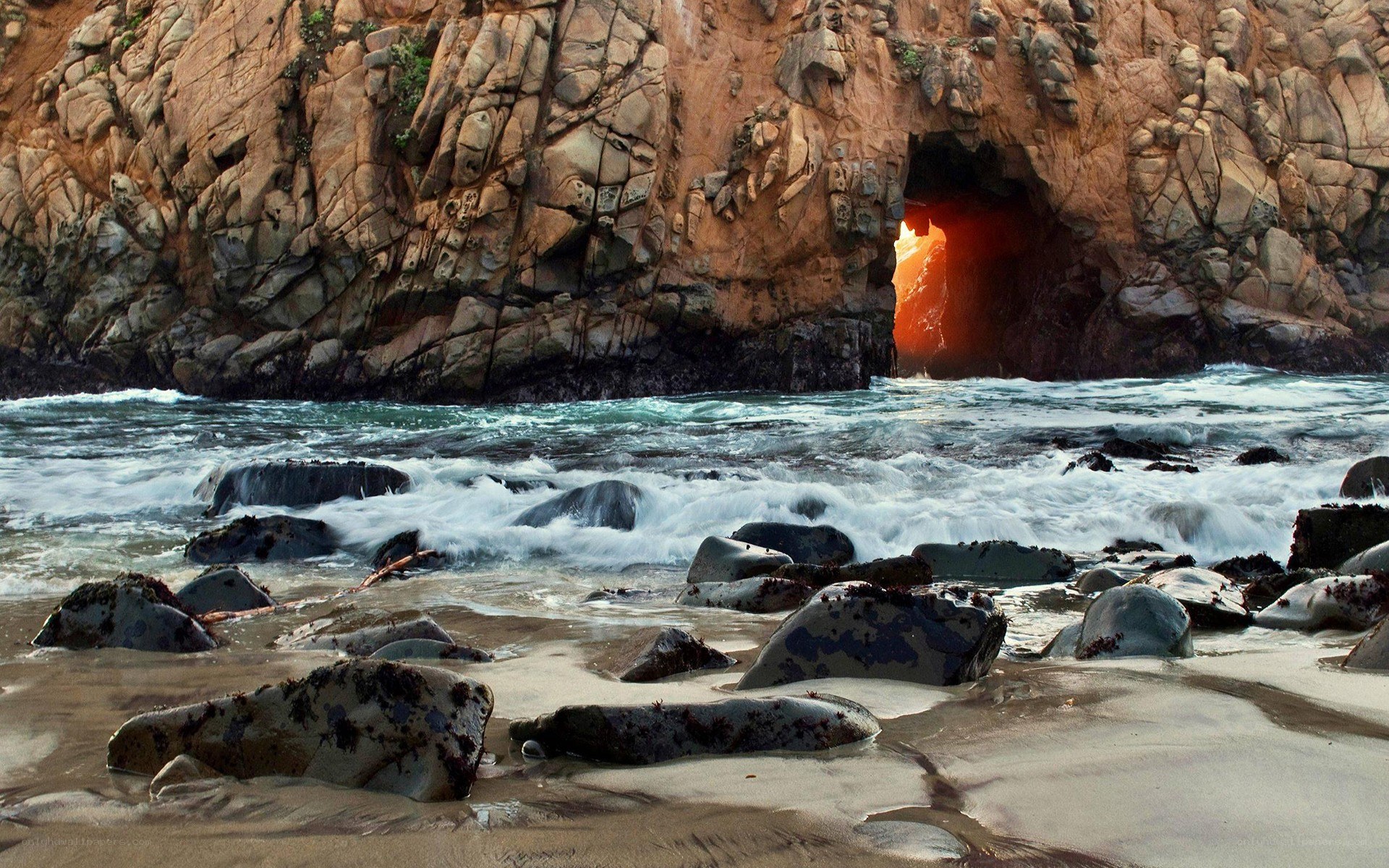 Sunset through sea cave