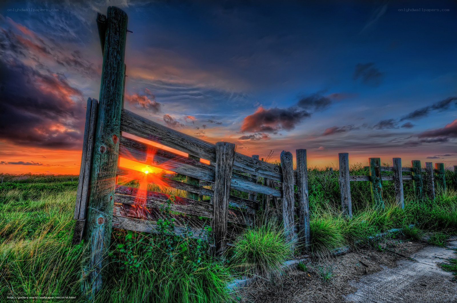 Sunset through wooden fence
