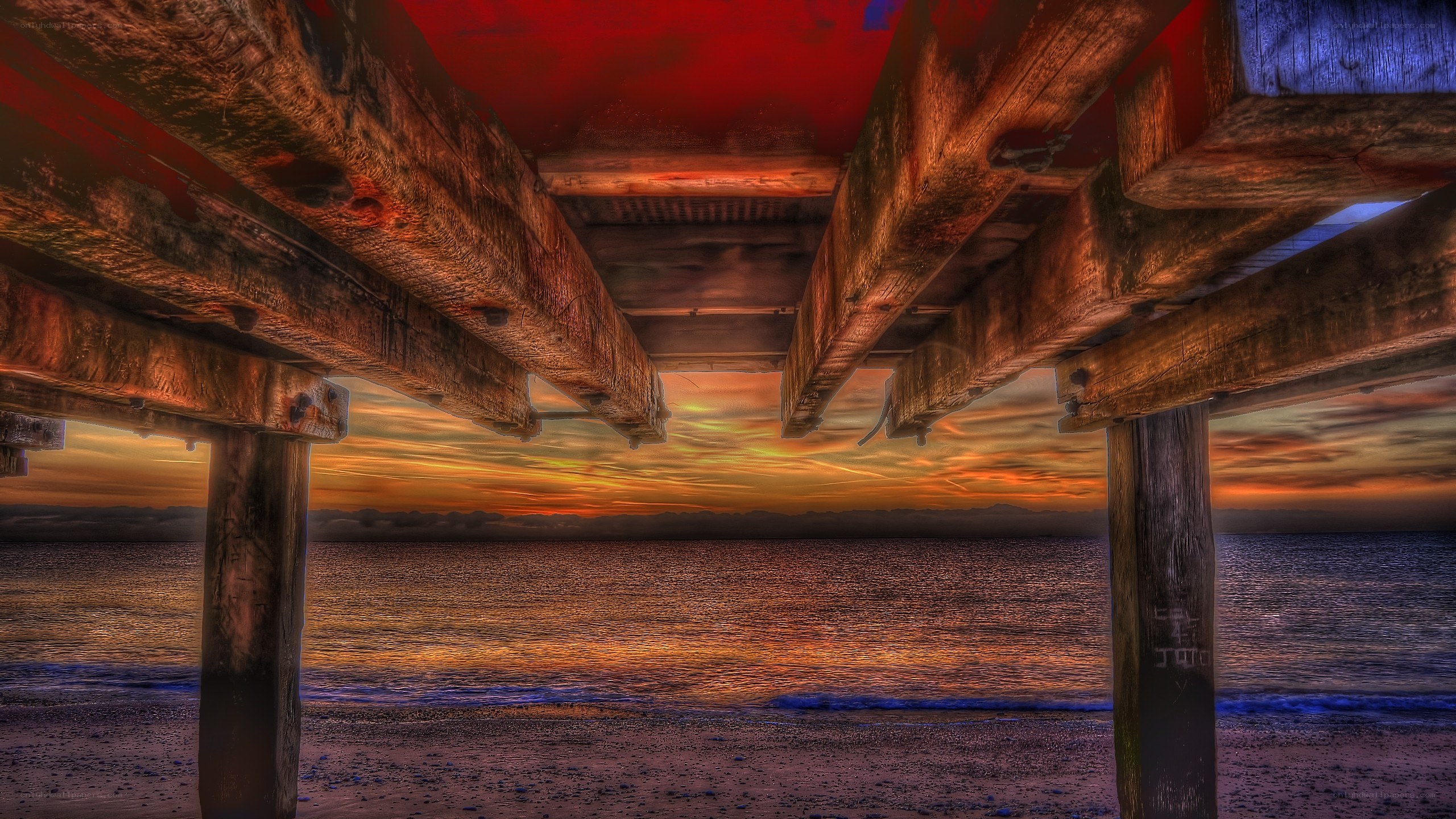 sunset under a wooden pier