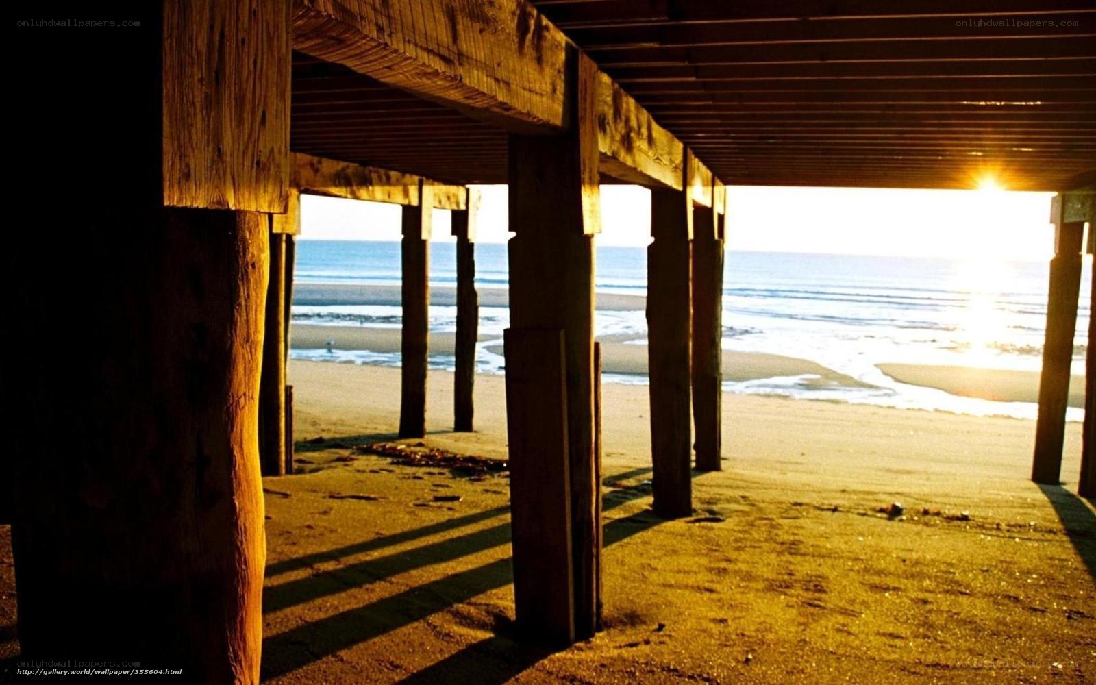 Sunset under a wooden pier