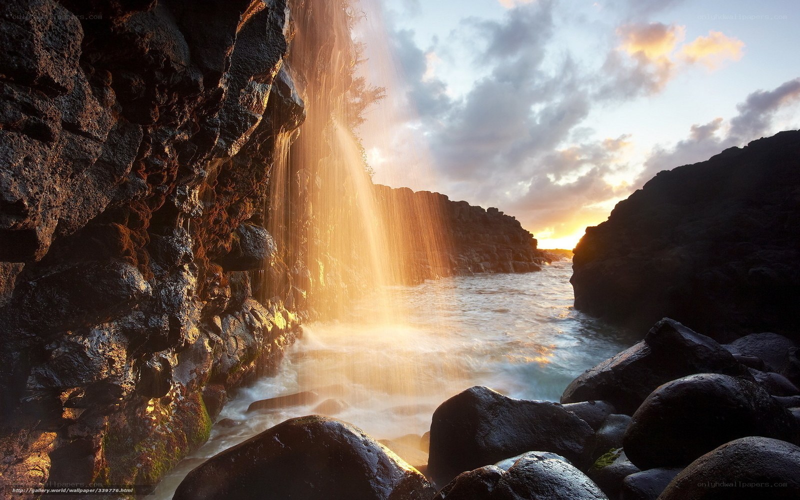 Sunset waterfall at rocky coast
