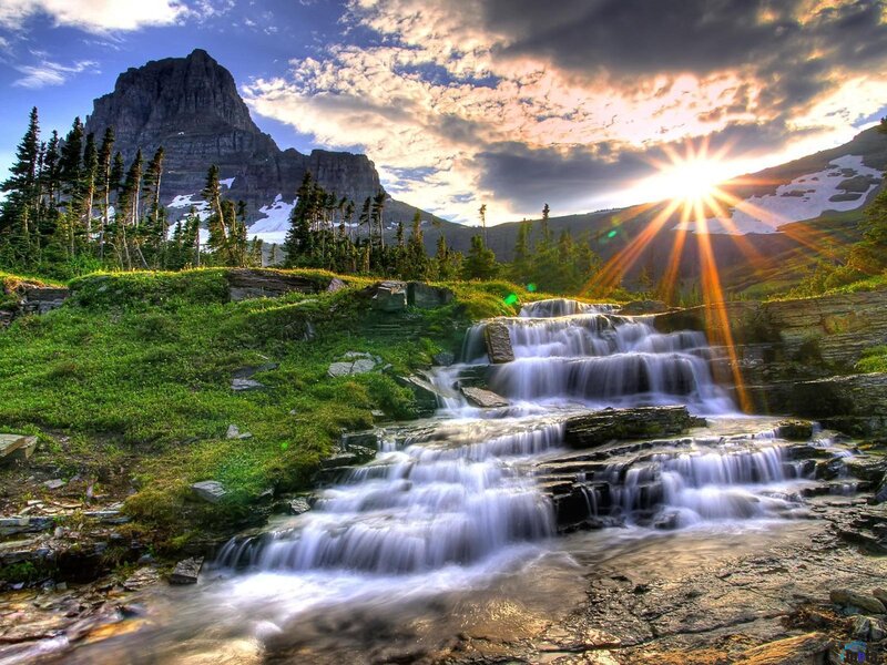 Sunset waterfall in mountain valley