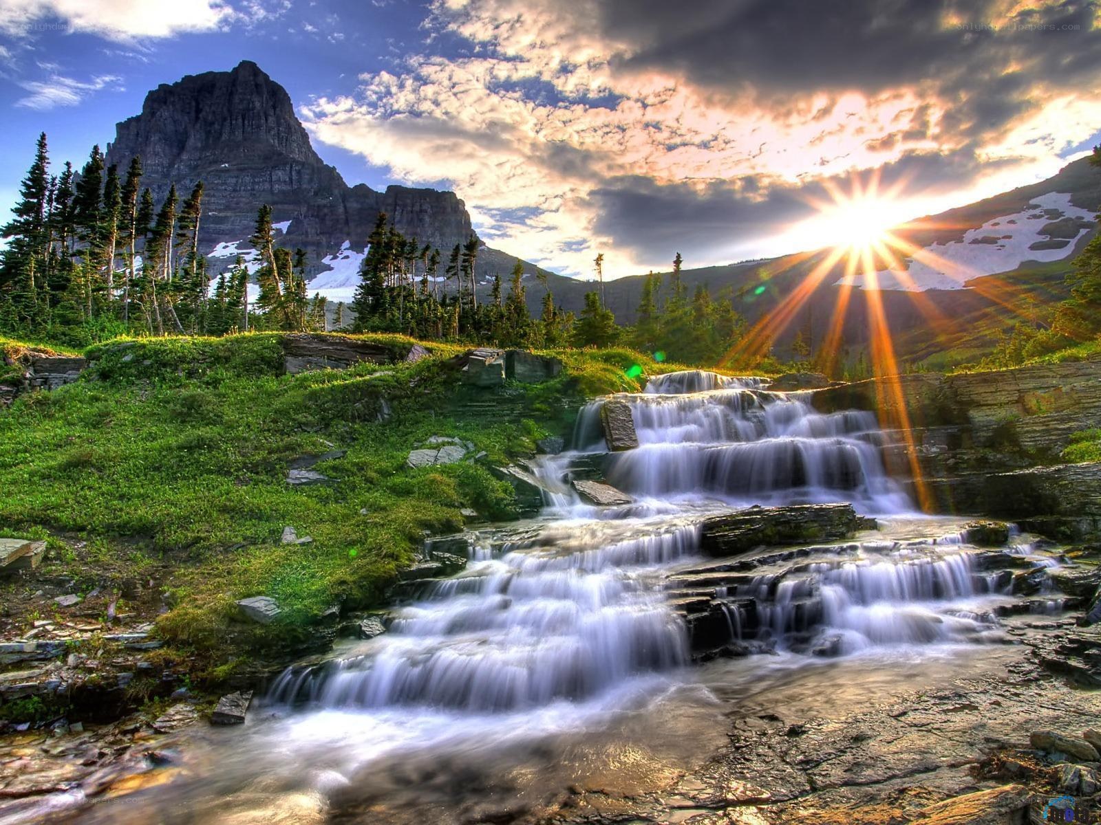 Sunset waterfall in mountain valley