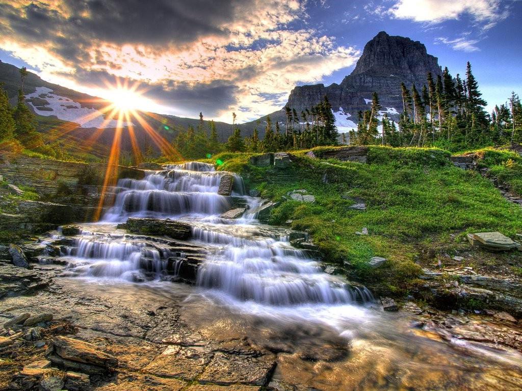 Sunset waterfall in mountain valley