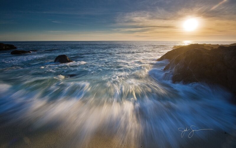 Sunset waves at rocky coast