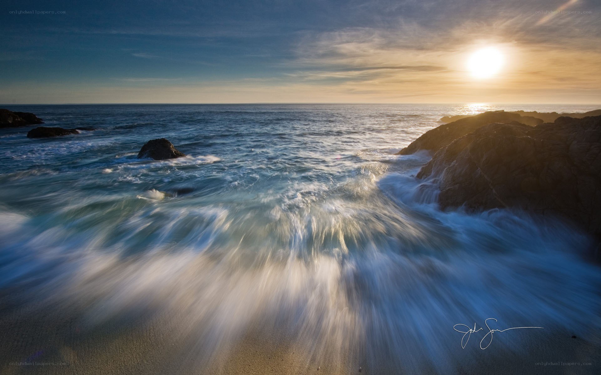 Sunset waves at rocky coast