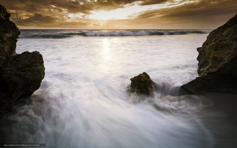 Sunset waves at rocky shore