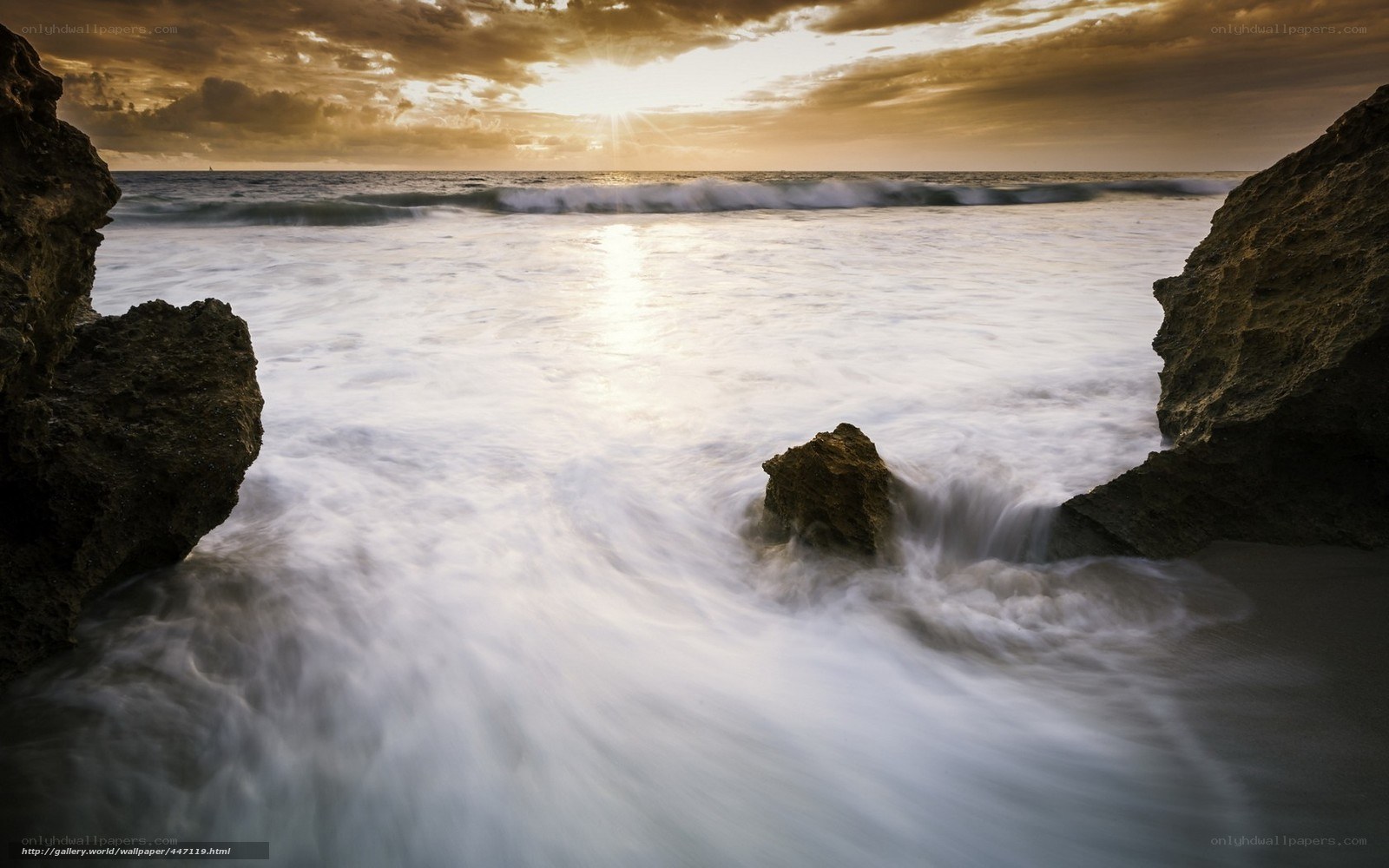 Sunset waves at rocky shore