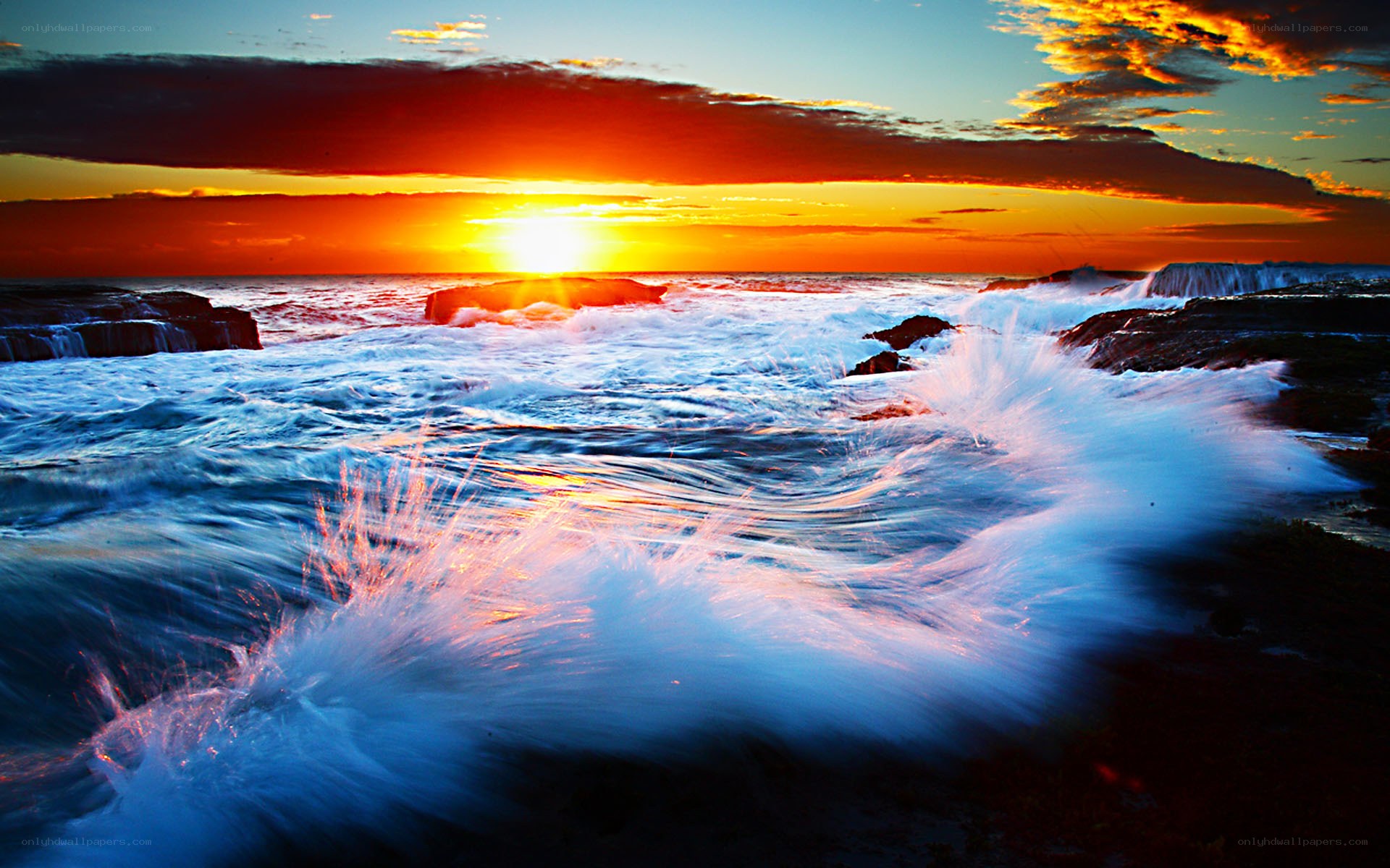 Sunset waves crashing on rocks