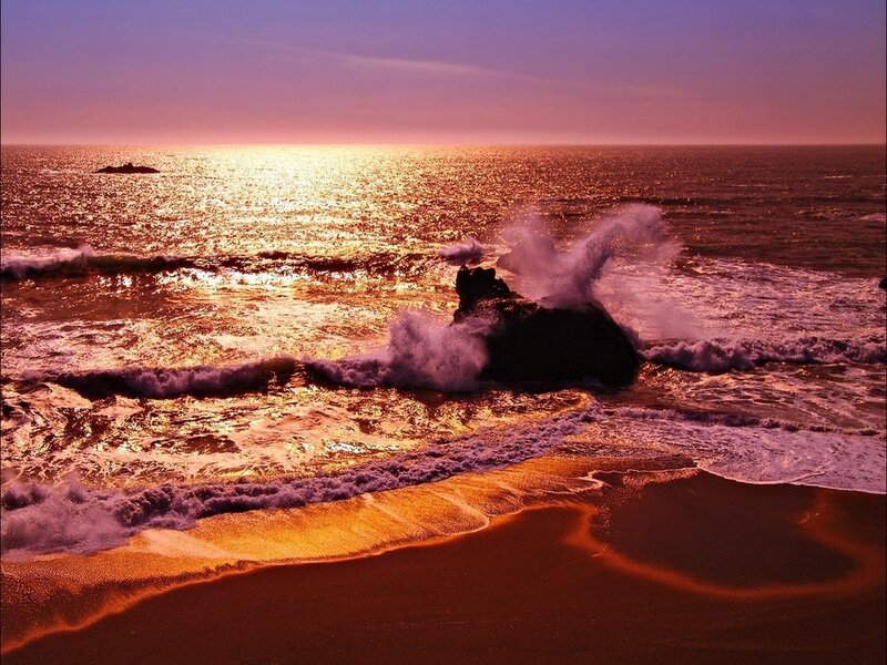 Sunset waves crashing on rocks