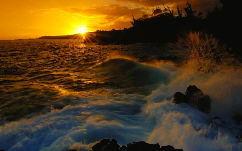 Sunset waves crashing on rocks