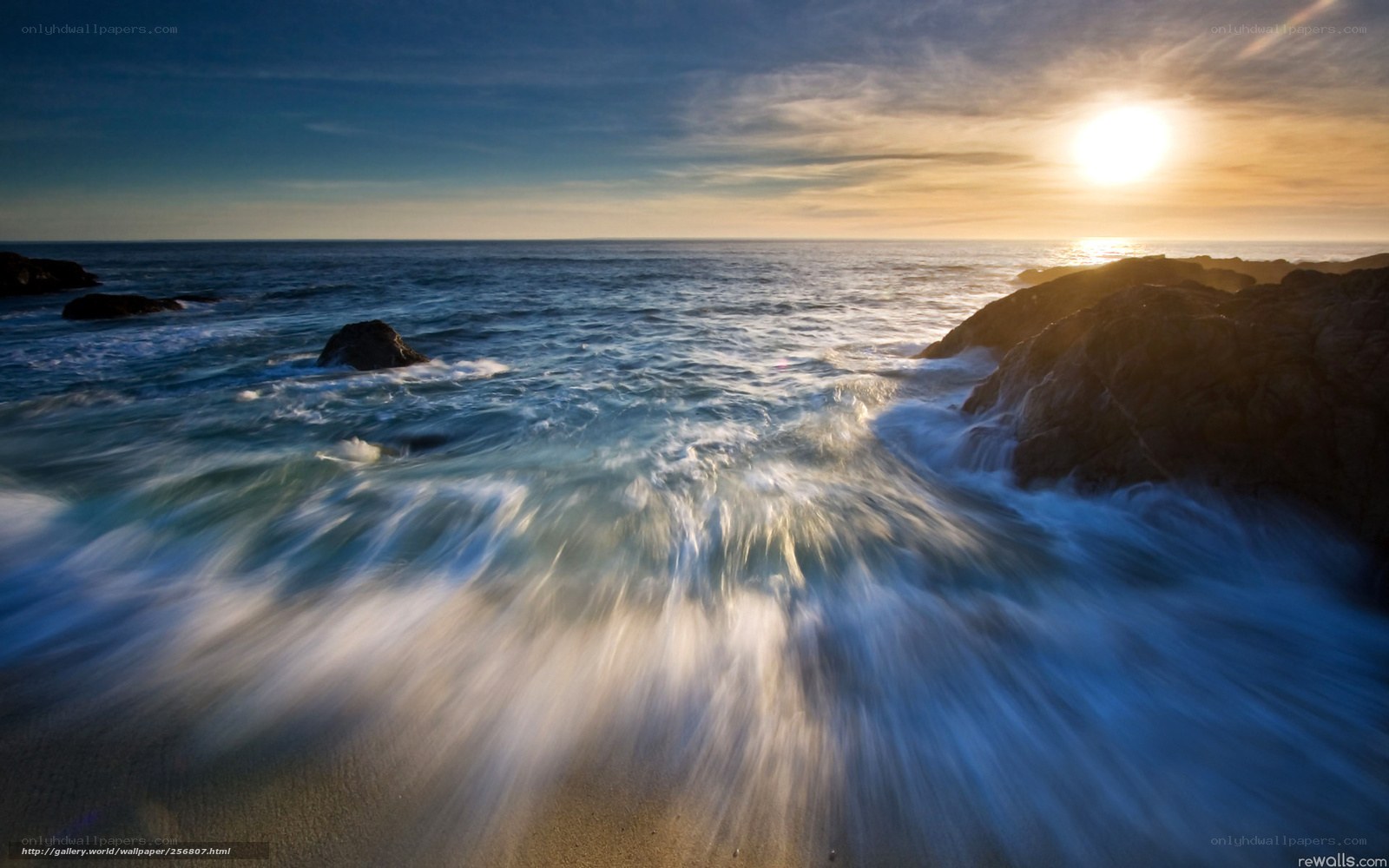 Sunset waves crashing on rocks